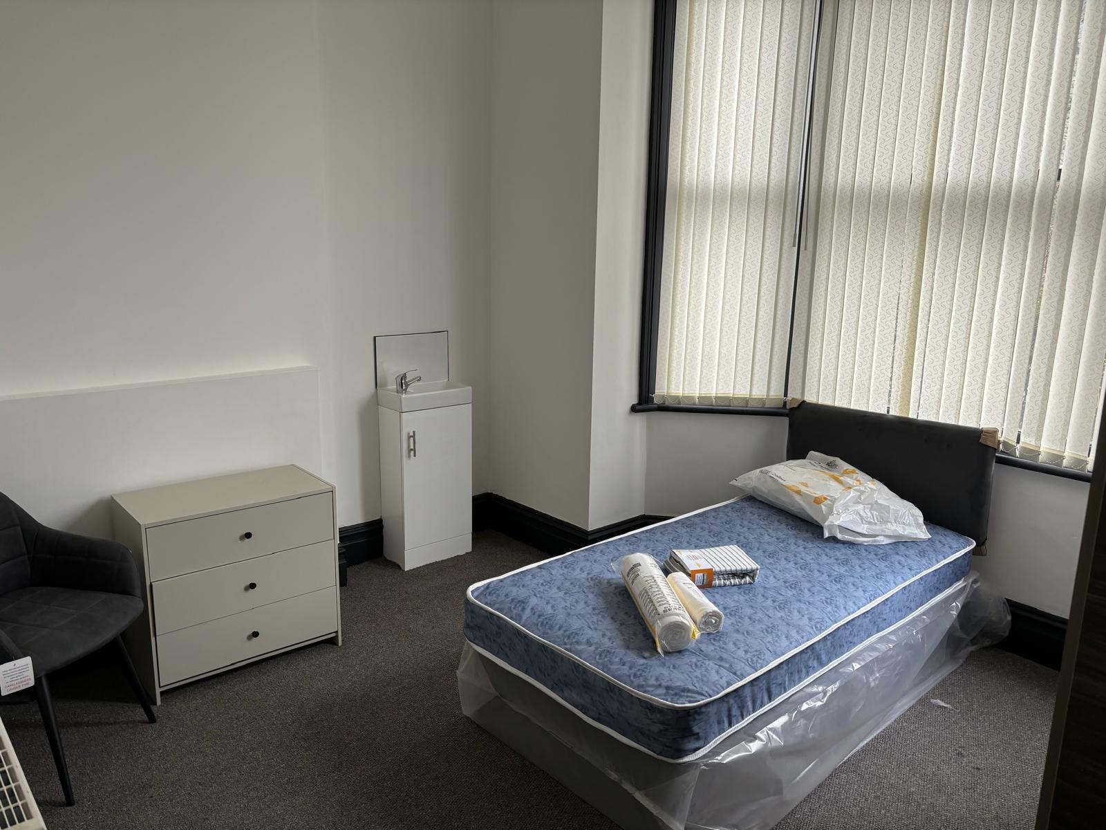 Furnished bedroom with en-suite basin